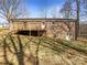 Backyard view of a brick home with a spacious wooden deck, ideal for outdoor entertaining and relaxation at 1420 Hickory Nut Ln, Lincolnton, NC 28092