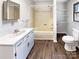 Clean bathroom featuring a shower-tub combo, a vanity with ample storage, and a window for natural light at 1420 Hickory Nut Ln, Lincolnton, NC 28092