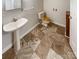 Updated bathroom featuring a pedestal sink, wood-look tile floors and a wooden toilet seat at 1420 Hickory Nut Ln, Lincolnton, NC 28092