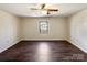 Bedroom featuring hardwood floors, ceiling fan, and a window offering natural light, creating a calming and inviting space at 1420 Hickory Nut Ln, Lincolnton, NC 28092