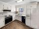 Traditional kitchen with classic white cabinetry, modern appliances, and hardwood floors, providing a functional cooking space at 1420 Hickory Nut Ln, Lincolnton, NC 28092