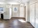 Bright kitchen featuring a door to the outside, white cabinets, and wood floors at 1420 Hickory Nut Ln, Lincolnton, NC 28092