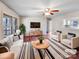 Bright living room with hardwood floors, a ceiling fan, and neutral paint colors, perfect for entertaining and relaxing at 1420 Hickory Nut Ln, Lincolnton, NC 28092