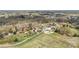 Expansive aerial view of a stunning home with a pool and multiple buildings on a large, lush, tree-lined property at 1620 London Rd, Mooresville, NC 28115