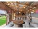 Outdoor bar area with rustic decor, neon signs, and custom seating at 1620 London Rd, Mooresville, NC 28115