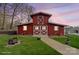 Quaint red barn with white trim, set on a green lawn with a stone pathway at 1620 London Rd, Mooresville, NC 28115