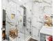 Sleek bathroom features a large glass shower, rainfall shower head, bench, and white marble tiling at 1620 London Rd, Mooresville, NC 28115