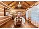 Charming dining room featuring wood walls, a large table set for six, and natural light from the windows at 1620 London Rd, Mooresville, NC 28115