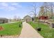 Sprawling exterior of the home showing a stone pathway and well-manicured lawn at 1620 London Rd, Mooresville, NC 28115