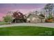 Charming home with a spacious driveway, well-manicured lawn, and picturesque landscaping at 1620 London Rd, Mooresville, NC 28115