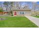 Charming home exterior with dormer windows, stone accents, and a vibrant red front door at 1620 London Rd, Mooresville, NC 28115