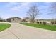Expansive home exterior featuring a long driveway, large yard, and partial water view at 1620 London Rd, Mooresville, NC 28115