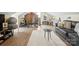 Inviting bonus room with a comfortable couch, exercise equipment, neutral colors, and wood floors at 1620 London Rd, Mooresville, NC 28115