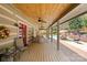 Covered patio with outdoor seating area overlooking the swimming pool at 1620 London Rd, Mooresville, NC 28115