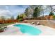 Kidney shaped Pool with patio, lounge chairs and stone retaining wall at 1620 London Rd, Mooresville, NC 28115