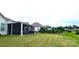 Spacious backyard featuring a screened-in porch and lush landscaping on a well-manicured lawn at 17436 Langston Dr, Charlotte, NC 28278
