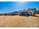 Spacious backyard featuring a well-maintained lawn and covered patio, perfect for outdoor relaxation at 17436 Langston Dr, Charlotte, NC 28278