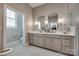 Bright bathroom with double vanity, two mirrors, and tile flooring; offering ample space at 17436 Langston Dr, Charlotte, NC 28278