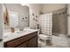 Cozy bathroom with a shower-tub combo and a vanity with dark wood cabinets at 17436 Langston Dr, Charlotte, NC 28278