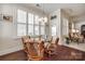Charming breakfast nook featuring a glass table, comfortable seating, plantation shutters, and ample natural light, great for casual dining at 17436 Langston Dr, Charlotte, NC 28278