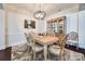 Elegant dining room with a decorative chandelier, wainscoting, and a wooden china cabinet at 17436 Langston Dr, Charlotte, NC 28278