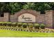 Stone monument sign at the entrance of Regency at Palisades community featuring manicured landscaping and lush greenery at 17436 Langston Dr, Charlotte, NC 28278
