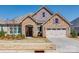 Charming stone facade home with a well-manicured front yard and a two-car garage at 17436 Langston Dr, Charlotte, NC 28278