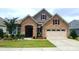 Beautiful stone and siding home with manicured lawn and two-car garage offers great curb appeal at 17436 Langston Dr, Charlotte, NC 28278