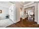 Bright hallway with hardwood floors leading to an office space and living room at 17436 Langston Dr, Charlotte, NC 28278