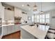 Bright kitchen featuring white cabinets, a central island, and modern fixtures, offering a stylish and functional cooking space at 17436 Langston Dr, Charlotte, NC 28278