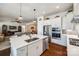 Bright, open kitchen with stainless steel appliances, an island, and seamless flow into the living and dining areas at 17436 Langston Dr, Charlotte, NC 28278