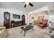Open-concept living space with cozy seating, an entertainment center, and adjacent dining area perfect for gatherings and relaxation at 17436 Langston Dr, Charlotte, NC 28278
