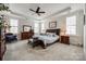 Spacious main bedroom featuring a tray ceiling, carpet, and an inviting seating area at 17436 Langston Dr, Charlotte, NC 28278