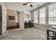 Bright office featuring large windows with blinds, a ceiling fan, and plush carpeting at 17436 Langston Dr, Charlotte, NC 28278