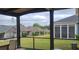 Relaxing screened-in patio with a view of the well-maintained backyard and neighboring homes at 17436 Langston Dr, Charlotte, NC 28278