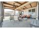 Inviting screened porch with ample seating, ceiling fans, and a view of the backyard at 17436 Langston Dr, Charlotte, NC 28278