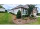 Well-maintained side yard with lush landscaping, mature trees, and decorative rock accents at 17436 Langston Dr, Charlotte, NC 28278