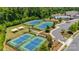 Aerial view of four well-maintained tennis courts in a lush, green community setting at 17436 Langston Dr, Charlotte, NC 28278