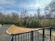 Balcony overlooks trees, landscaping, and a paved road and parking area at 2043 Clarksdale St # 31, Charlotte, NC 28206