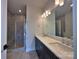 Bathroom featuring a double vanity, stone countertop, and tiled glass enclosed shower at 2043 Clarksdale St # 31, Charlotte, NC 28206