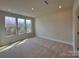 Carpeted bedroom with three large windows and recessed lighting at 2043 Clarksdale St # 31, Charlotte, NC 28206