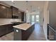Modern kitchen features a central island with quartz countertops and stainless steel appliances at 2043 Clarksdale St # 31, Charlotte, NC 28206