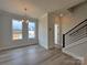 Bright living room featuring sleek flooring, large windows, and a modern staircase at 2043 Clarksdale St # 31, Charlotte, NC 28206