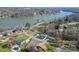 Aerial view of the lakefront property surrounded by mature trees with a tennis court nearby at 2052 10Th Street Nw Pl, Hickory, NC 28601