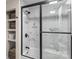 Bathroom with a tub-shower combo with black trim and sliding glass door, a tiled wall, and built-in shelving at 2052 10Th Street Nw Pl, Hickory, NC 28601