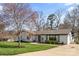 Charming single-story home featuring a well-manicured lawn and neutral paint with mature trees under a bright blue sky at 2052 10Th Street Nw Pl, Hickory, NC 28601