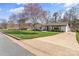 Charming home with a well-maintained lawn, mature trees, and a paved driveway at 2052 10Th Street Nw Pl, Hickory, NC 28601