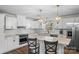 Well-lit, modern kitchen with white cabinetry, an island, and stainless steel appliances at 2052 10Th Street Nw Pl, Hickory, NC 28601