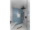 Contemporary shower featuring blue accent tiles, white marble, a built-in niche, and a seat at 2052 10Th Street Nw Pl, Hickory, NC 28601