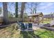 Lush backyard featuring a gazebo with seating, a fire pit area, and a beautifully landscaped garden at 209 S Gardner Ave, Charlotte, NC 28208